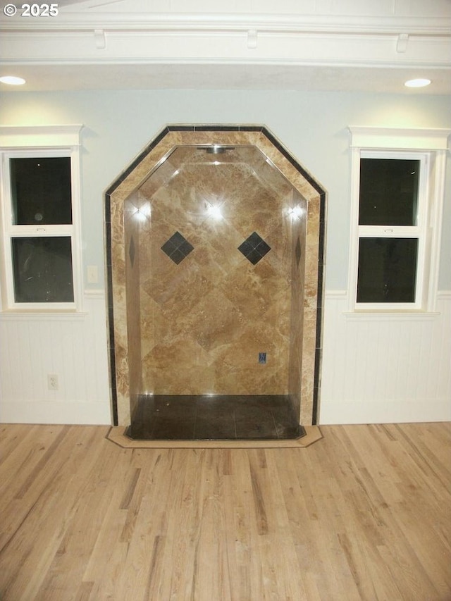 details featuring wood finished floors and a wainscoted wall