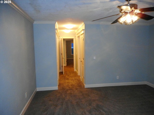 carpeted spare room with baseboards, ceiling fan, and ornamental molding