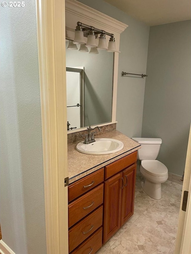 bathroom with an enclosed shower, toilet, and vanity