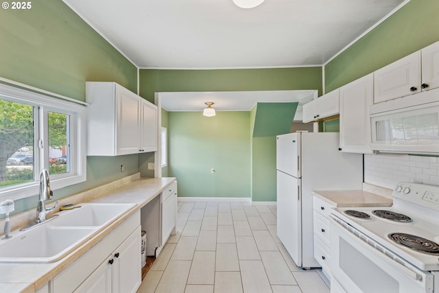 1296 W Central Blvd, Coquille, OR 97423 - kitchen with white appliances, white cabinets, decorative backsplash, light countertops, and ornamental molding