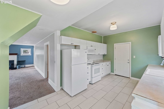 1296 W Central Blvd, Coquille, OR 97423 - kitchen with white appliances, white cabinetry, light countertops, light tile patterned flooring, and light colored carpet