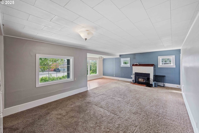 1296 W Central Blvd, Coquille, OR 97423 - unfurnished living room featuring carpet flooring and a wood stove