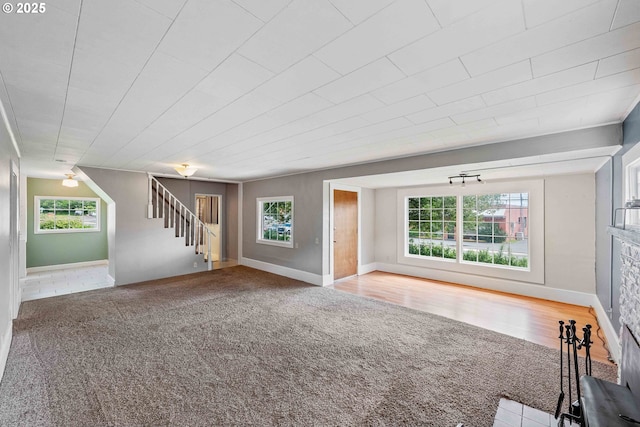 1296 W Central Blvd, Coquille, OR 97423 - unfurnished living room with healthy amount of natural light, stairs, and carpet