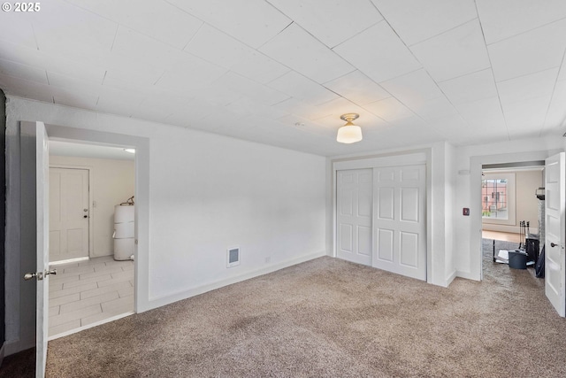 1296 W Central Blvd, Coquille, OR 97423 - unfurnished bedroom featuring carpet flooring, a closet, water heater, and ensuite bathroom