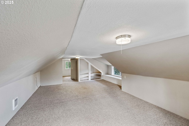 1296 W Central Blvd, Coquille, OR 97423 - additional living space featuring vaulted ceiling, a textured ceiling, and carpet floors
