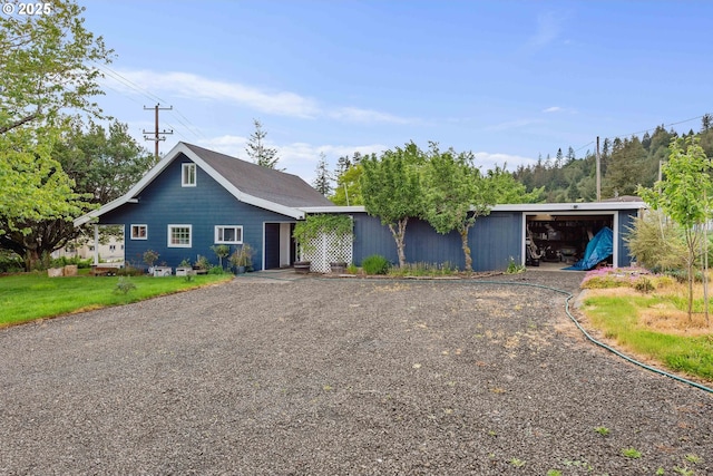 1296 W Central Blvd, Coquille, OR 97423 - view of front of house with a detached garage, an outdoor structure, an outbuilding, and gravel driveway
