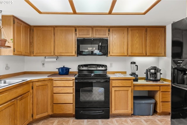 4131 Jessen Dr, Eugene, OR 97402 - kitchen with black appliances, light countertops, and brown cabinets