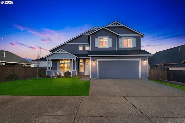 view of front of house featuring covered porch, concrete driveway, an attached garage, a front yard, and fence