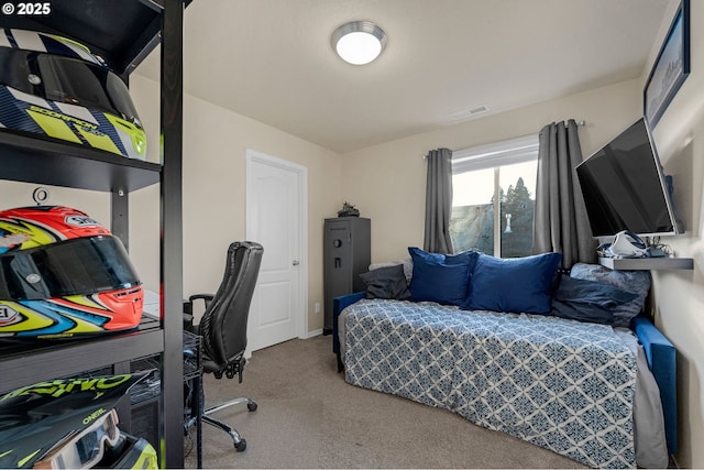 carpeted bedroom featuring visible vents