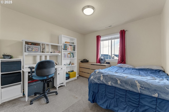 bedroom with visible vents and light colored carpet