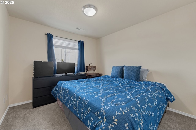 carpeted bedroom featuring baseboards and visible vents