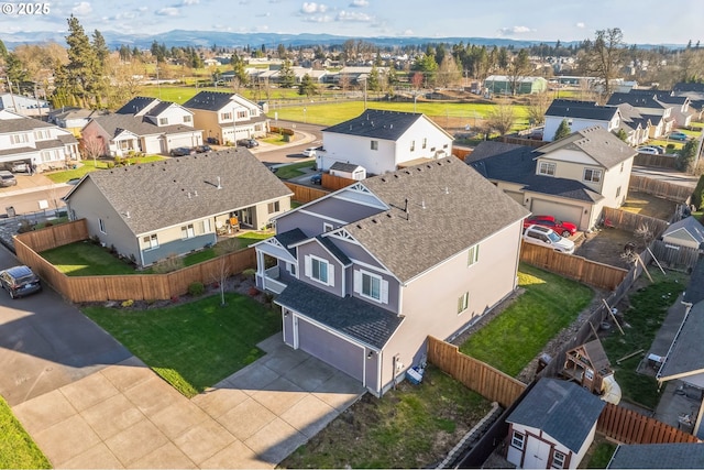 drone / aerial view featuring a residential view and a mountain view