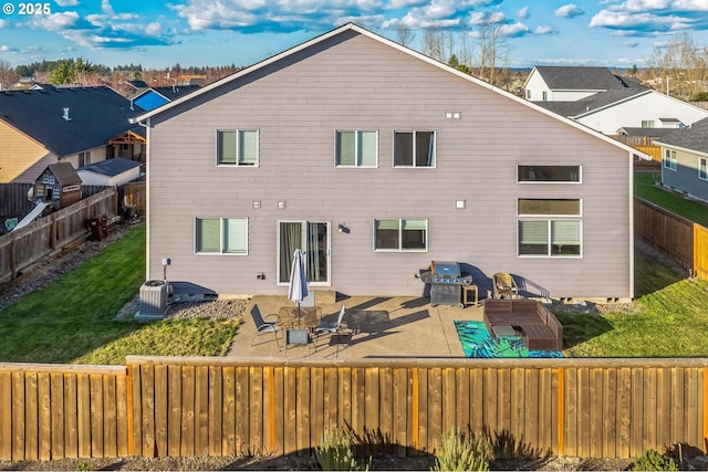 rear view of house featuring a lawn, a patio area, a fenced backyard, and a residential view