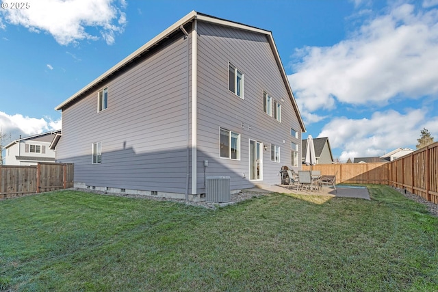 rear view of property featuring central AC, a patio area, a lawn, and a fenced backyard