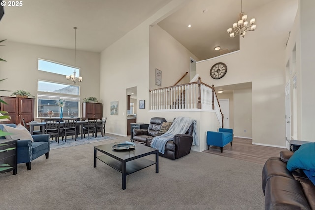 living area featuring stairs, carpet floors, a high ceiling, and an inviting chandelier