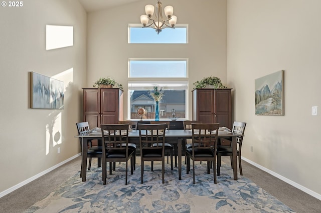 dining space featuring an inviting chandelier, baseboards, and carpet flooring