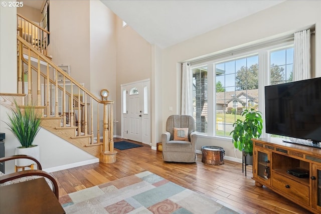 5277 Landon St, Salem, OR 97306 - foyer entrance featuring wood finished floors, stairway, high vaulted ceiling, and baseboards