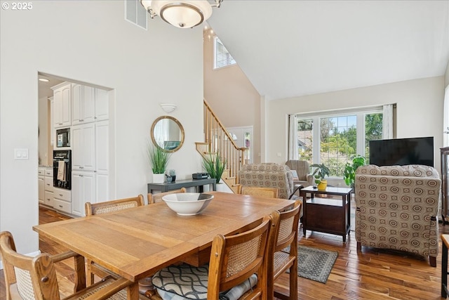 5277 Landon St, Salem, OR 97306 - dining room featuring high vaulted ceiling, stairway, and light wood-style flooring