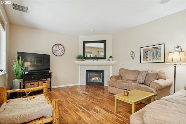 5277 Landon St, Salem, OR 97306 - living room with wood finished floors, a tiled fireplace, and baseboards