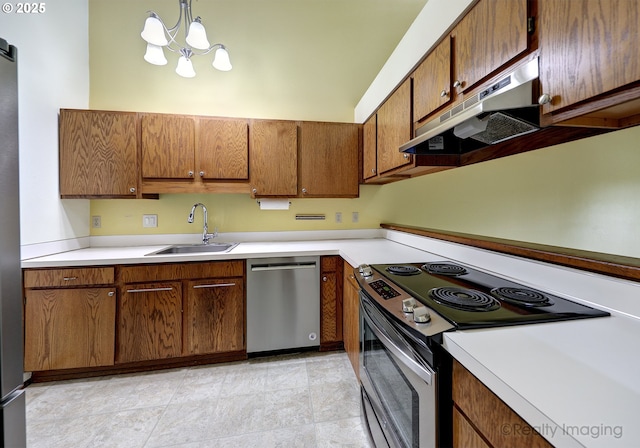 13775 SW Scholls Ferry Rd Unit 16, Beaverton, OR 97008 - kitchen featuring appliances with stainless steel finishes, under cabinet range hood, light countertops, a chandelier, and brown cabinets