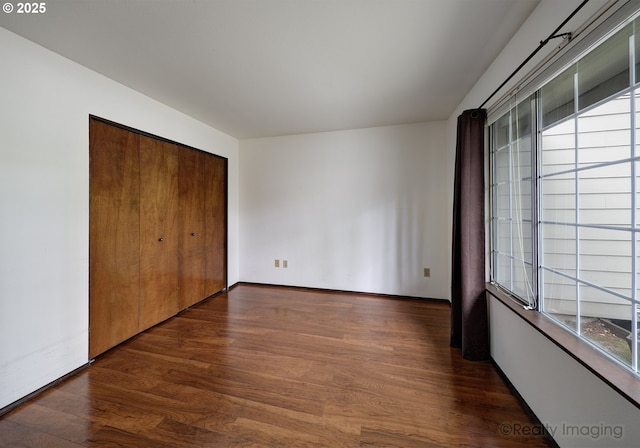 13775 SW Scholls Ferry Rd Unit 16, Beaverton, OR 97008 - unfurnished bedroom with multiple windows, dark wood-type flooring, and a closet