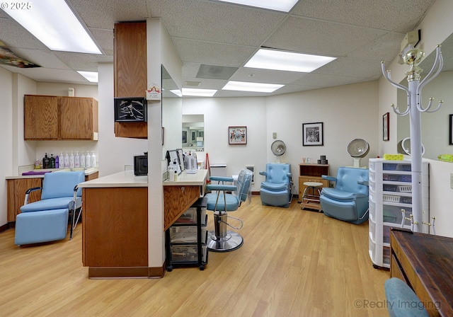 13775 SW Scholls Ferry Rd Unit 16, Beaverton, OR 97008 - kitchen with a paneled ceiling, light wood-style flooring, open floor plan, and a breakfast bar area