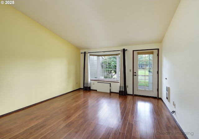 13775 SW Scholls Ferry Rd Unit 16, Beaverton, OR 97008 - unfurnished room with dark wood finished floors, vaulted ceiling, and heating unit