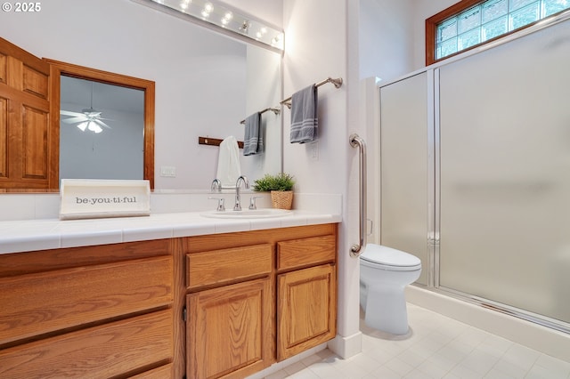 32680 SW Lake Point Ct, Wilsonville, OR 97070 - bathroom with vanity, a stall shower, toilet, ceiling fan, and tile patterned floors