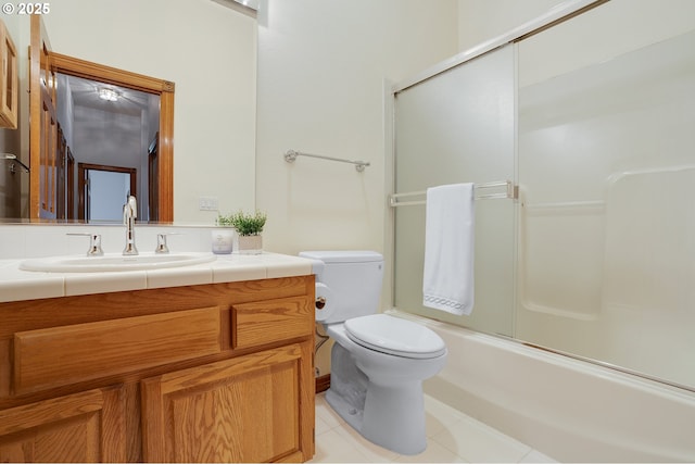 32680 SW Lake Point Ct, Wilsonville, OR 97070 - full bathroom with vanity, tile patterned floors, toilet, and bath / shower combo with glass door