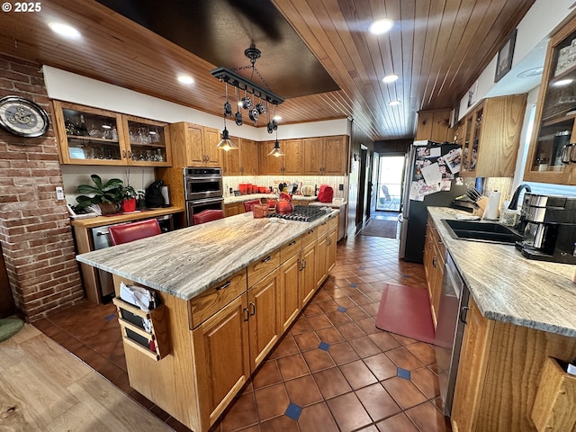 kitchen featuring a kitchen island, decorative light fixtures, stainless steel appliances, sink, and wooden ceiling