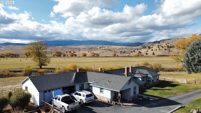 birds eye view of property with a mountain view and a rural view