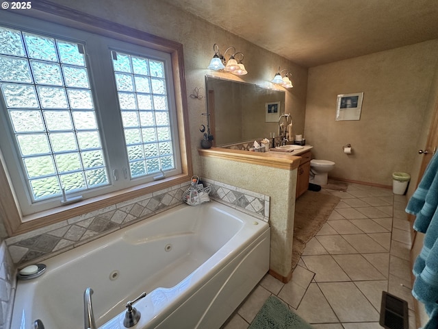 bathroom with toilet, a bath, vanity, and tile patterned flooring