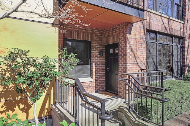 doorway to property with brick siding