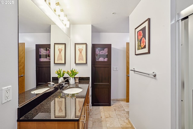 full bath with baseboards and vanity