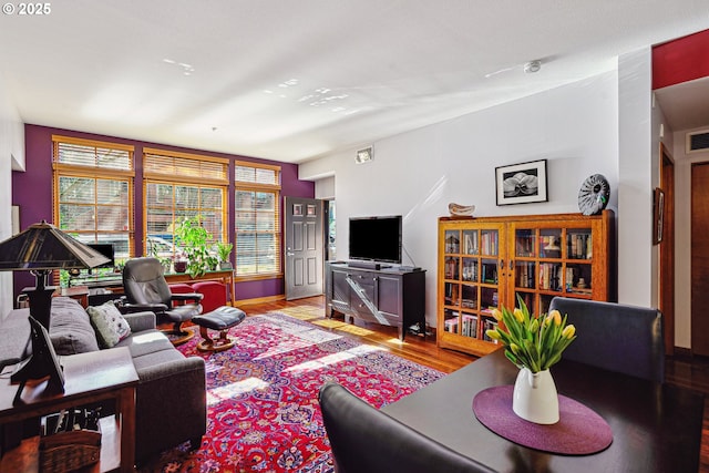 living room featuring visible vents and wood finished floors