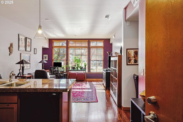 office space featuring dark wood-style flooring, a sink, and baseboards