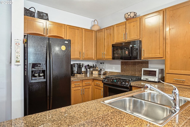 kitchen featuring a toaster, a sink, tile counters, brown cabinets, and black appliances