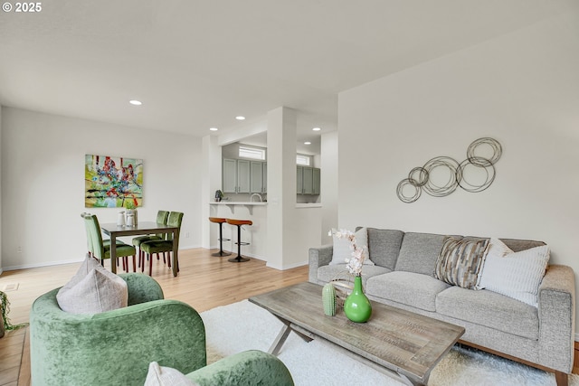 697 NW Rubus Ln, Hillsboro, OR 97124 - living room featuring light wood-style flooring, recessed lighting, and baseboards