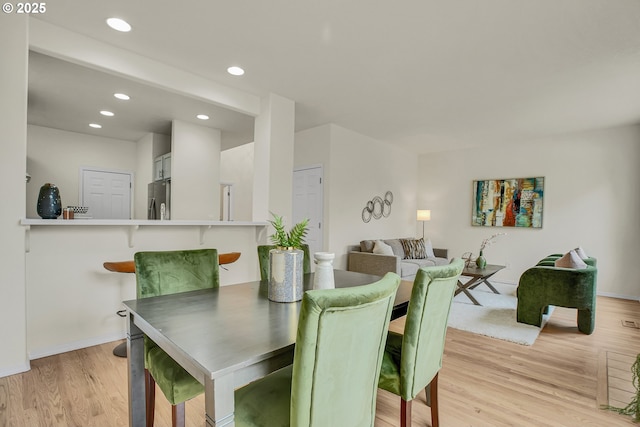 697 NW Rubus Ln, Hillsboro, OR 97124 - dining area featuring light wood-style floors, baseboards, and recessed lighting