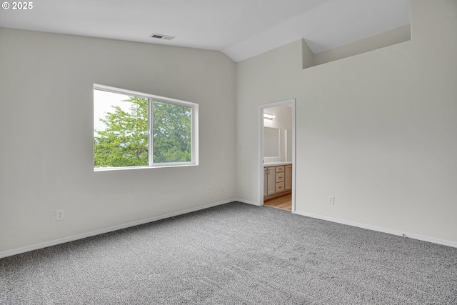 697 NW Rubus Ln, Hillsboro, OR 97124 - spare room featuring light carpet, lofted ceiling, and baseboards