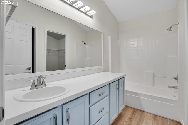 697 NW Rubus Ln, Hillsboro, OR 97124 - bathroom featuring vanity, wood finished floors, and shower / tub combination
