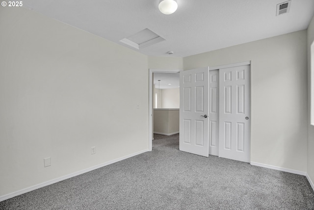 697 NW Rubus Ln, Hillsboro, OR 97124 - unfurnished bedroom featuring carpet floors, baseboards, a closet, and attic access