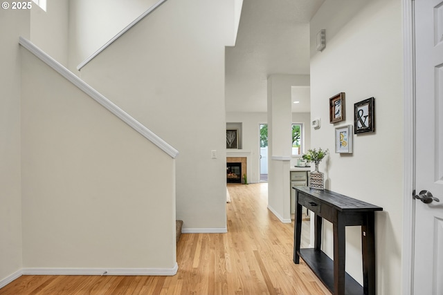 697 NW Rubus Ln, Hillsboro, OR 97124 - entryway featuring light wood-style floors, baseboards, and a tile fireplace
