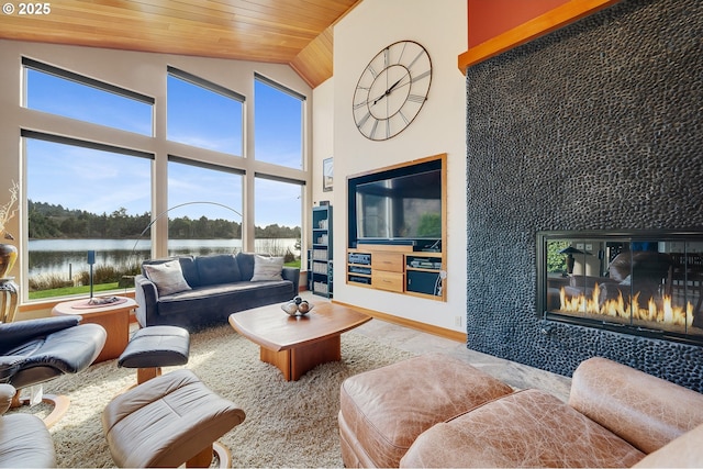 living area with wood ceiling, a water view, and high vaulted ceiling