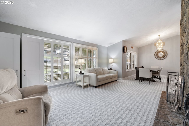 living area with a textured ceiling, an inviting chandelier, dark colored carpet, baseboards, and vaulted ceiling