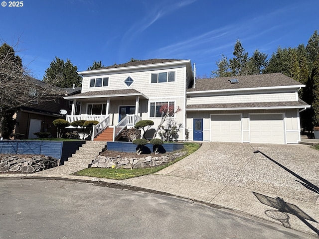 traditional home with a garage, covered porch, a shingled roof, and concrete driveway