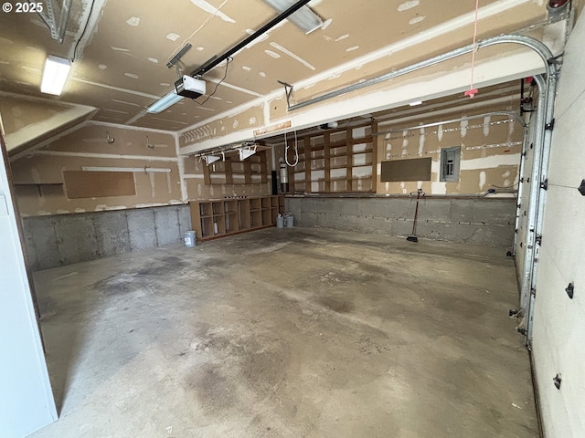 garage featuring electric panel and a garage door opener