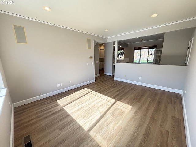 empty room featuring recessed lighting, visible vents, baseboards, and wood finished floors