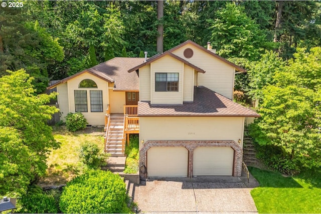 20916 SW Siletz Ct, Tualatin, OR 97062 - tri-level home with concrete driveway, an attached garage, brick siding, a shingled roof, and stairs