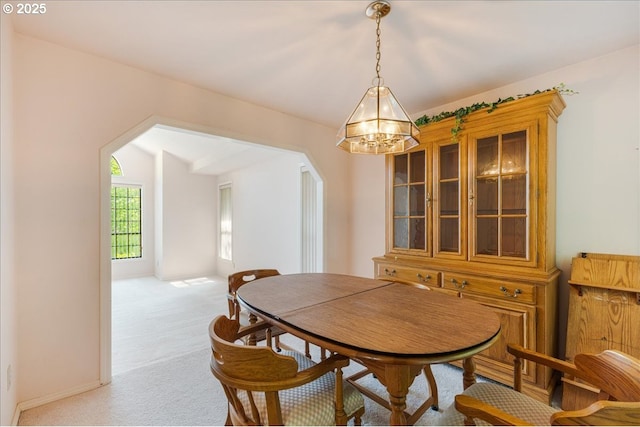 20916 SW Siletz Ct, Tualatin, OR 97062 - carpeted dining room featuring a chandelier, arched walkways, and lofted ceiling